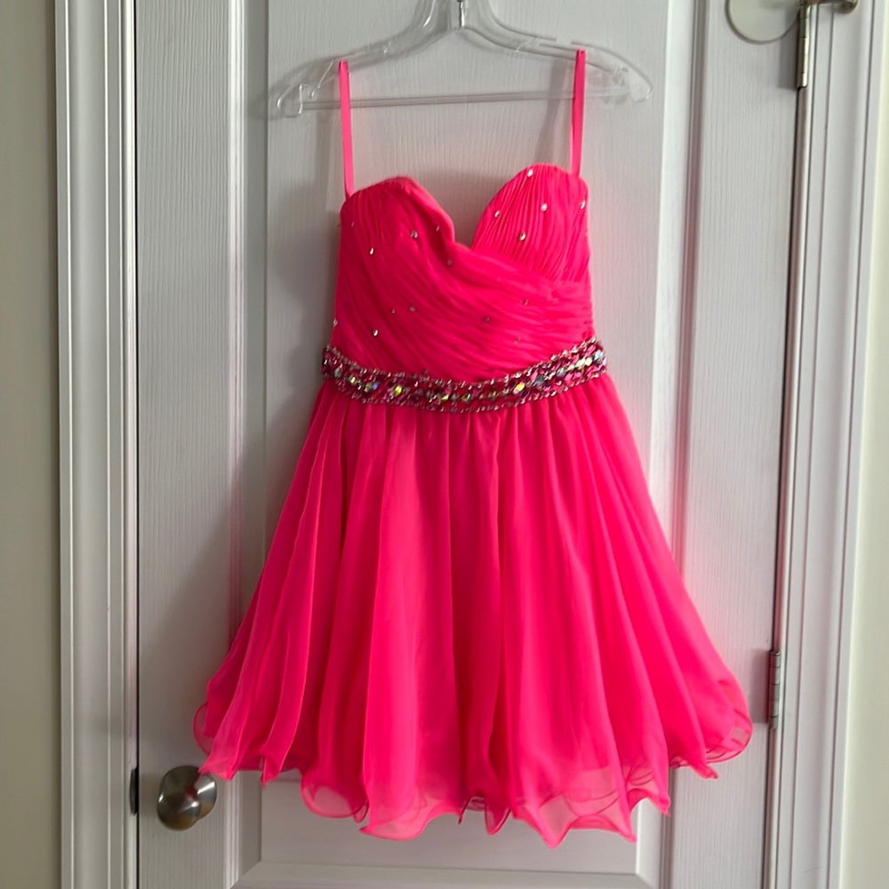 Hot pink strapless dress with gem- accented waist and bodice